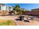 Outdoor patio with lounge furniture, a decorative fire pit, and beautiful palm trees, perfect for enjoying the outdoor living at 1737 S Talbot --, Mesa, AZ 85209