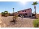 Expansive backyard with mature palm trees, a decorative fountain, and a covered patio at 1737 S Talbot --, Mesa, AZ 85209
