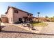 Backyard features a patio area with seating, a built-in fire pit, and mature palm trees, ideal for outdoor enjoyment at 1737 S Talbot --, Mesa, AZ 85209