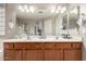 Bright bathroom with double sinks, a large mirror, and a shower at 1737 S Talbot --, Mesa, AZ 85209