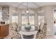 Charming breakfast nook with round table, cushioned chairs, and natural light from bay windows at 1737 S Talbot --, Mesa, AZ 85209