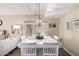 Bright dining room with a farmhouse-style table set under a modern pendant light fixture, perfect for gatherings at 1737 S Talbot --, Mesa, AZ 85209