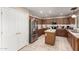 Well-lit kitchen with stainless steel appliances, center island, granite countertops, and wood cabinets at 1737 S Talbot --, Mesa, AZ 85209