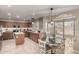 Well-equipped kitchen with wood cabinetry, stainless steel appliances, and an adjacent dining area at 1737 S Talbot --, Mesa, AZ 85209