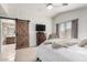 Bright bedroom with vaulted ceilings, carpet floors, rustic barn door to bath, and large window at 1737 S Talbot --, Mesa, AZ 85209