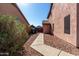 Spacious side yard with a gravel pathway leading to a detached garage or shed, offering ample space for storage at 1737 S Talbot --, Mesa, AZ 85209