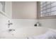Inviting bathtub with clean white tile, and glass block window at 1737 S Talbot --, Mesa, AZ 85209