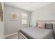 Bright bedroom featuring a cozy bed with a window and stylish artwork at 17784 W Sandy Rd, Goodyear, AZ 85338