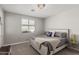 Serene bedroom with a cozy bed, neutral color scheme, and ample natural light from a window at 17784 W Sandy Rd, Goodyear, AZ 85338