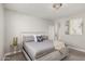 Bright bedroom with a stylish bed frame, soft carpet, and a decorative chandelier at 17784 W Sandy Rd, Goodyear, AZ 85338