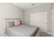 Bedroom featuring a bed with decorative pillows and a closet with sliding doors at 17784 W Sandy Rd, Goodyear, AZ 85338