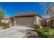 Side view of a single-story home with a two-car garage and desert landscaping at 17784 W Sandy Rd, Goodyear, AZ 85338