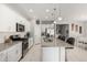 Modern kitchen featuring white cabinets, stainless steel appliances, and a granite-topped island with seating at 17784 W Sandy Rd, Goodyear, AZ 85338