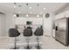 Kitchen island featuring barstool seating, stainless appliances, stylish pendant lighting, and white cabinets at 17784 W Sandy Rd, Goodyear, AZ 85338