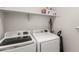 Functional laundry room featuring white appliances and convenient shelving for storage at 17784 W Sandy Rd, Goodyear, AZ 85338