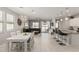 Open-concept living room seamlessly connects kitchen and dining area, perfect for entertaining with access to a backyard at 17784 W Sandy Rd, Goodyear, AZ 85338