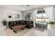 Cozy living room featuring a comfortable sectional sofa, natural wood table, and access to the outdoor pool area at 17784 W Sandy Rd, Goodyear, AZ 85338