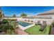 Backyard oasis featuring a pool, manicured lawn, and comfortable seating for outdoor relaxation at 17784 W Sandy Rd, Goodyear, AZ 85338