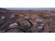 A dusk aerial view of the surrounding desert neighborhood and custom homes in the Phoenix valley at 1805 E Rocky Slope Dr, Phoenix, AZ 85048