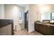 Modern bathroom featuring a vessel sink, stone accents, and glass enclosed shower, filled with natural light at 1805 E Rocky Slope Dr, Phoenix, AZ 85048