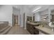A luxury bathroom with double vanities, soaking tub, and walk-in closet, featuring tile floors at 1805 E Rocky Slope Dr, Phoenix, AZ 85048