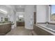 Bathroom featuring double sinks, dark cabinetry, a soaking tub, and large window with a view at 1805 E Rocky Slope Dr, Phoenix, AZ 85048