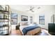 Spacious bedroom with neutral tones, hardwood floors, and a ceiling fan, offers scenic outdoor views through its black-trimmed windows at 1805 E Rocky Slope Dr, Phoenix, AZ 85048