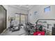 Well-equipped home gym featuring a variety of exercise machines, free weights, and bright natural lighting at 1805 E Rocky Slope Dr, Phoenix, AZ 85048
