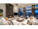 Elegant living room with a cozy fireplace and stunning views through expansive windows at 1805 E Rocky Slope Dr, Phoenix, AZ 85048
