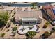Inviting backyard featuring an outdoor kitchen, patio, seating, and desert landscaping at 18514 N Laguna Azul Ct, Surprise, AZ 85374