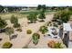 Beautiful backyard with covered patio, outdoor kitchen, desert landscaping, and a view of the golf course at 18514 N Laguna Azul Ct, Surprise, AZ 85374