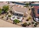 Relaxing backyard featuring an extended patio, outdoor seating, a built-in grill, and mature landscaping at 18514 N Laguna Azul Ct, Surprise, AZ 85374