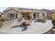 This large patio with a built-in cooking area offers multiple dining and relaxation spots with golf course views at 18514 N Laguna Azul Ct, Surprise, AZ 85374