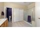 Spacious bathroom with tile flooring, large closet, and a glass-enclosed shower at 18514 N Laguna Azul Ct, Surprise, AZ 85374