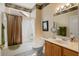 Well-lit bathroom with a shower-tub combination, vanity with drawers and a mirror at 18514 N Laguna Azul Ct, Surprise, AZ 85374