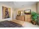 Cozy bedroom features a chest of drawers, a TV, and natural light at 18514 N Laguna Azul Ct, Surprise, AZ 85374