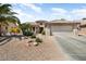 Inviting single-story home featuring a xeriscaped yard and tile roof at 18514 N Laguna Azul Ct, Surprise, AZ 85374