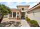 Close up of front of house with walkway, desert landscaping, and security door at 18514 N Laguna Azul Ct, Surprise, AZ 85374