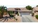 Charming home featuring low maintenance desert landscaping and a two-car garage at 18514 N Laguna Azul Ct, Surprise, AZ 85374