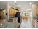 Updated kitchen with granite counters, wood cabinets, and adjacent eat-in dining area at 18514 N Laguna Azul Ct, Surprise, AZ 85374