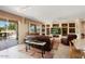 Bright living room with custom shelving and easy access to patio and kitchen at 18514 N Laguna Azul Ct, Surprise, AZ 85374