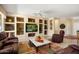 Comfortable living room featuring custom built-ins, ceiling fan and neutral paint colors at 18514 N Laguna Azul Ct, Surprise, AZ 85374