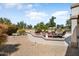 This outdoor kitchen and dining area with its built-in BBQ and desert landscaping is great for entertaining at 18514 N Laguna Azul Ct, Surprise, AZ 85374