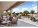 Spacious covered patio featuring comfortable seating and a built-in barbecue, perfect for outdoor entertaining at 18514 N Laguna Azul Ct, Surprise, AZ 85374