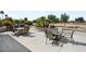 Outdoor dining and relaxation space with views of desert landscaping and a golf course at 18514 N Laguna Azul Ct, Surprise, AZ 85374