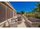Inviting back patio features stylish wicker seating, a cozy fire pit, and views of lush landscaping at 18867 N Cactus Flower Way, Surprise, AZ 85387