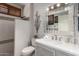 Updated bathroom featuring sleek white tile, modern fixtures, and decorative mirror at 18867 N Cactus Flower Way, Surprise, AZ 85387