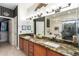Bathroom featuring double sinks, granite countertops, a soaking tub, and a glass enclosed shower at 18867 N Cactus Flower Way, Surprise, AZ 85387