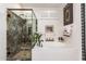 Bathroom showcasing a modern tub, and a glass enclosed shower at 18867 N Cactus Flower Way, Surprise, AZ 85387