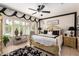 Charming bedroom showcasing a plush bed, ornate accents, and abundant natural light from shuttered windows at 18867 N Cactus Flower Way, Surprise, AZ 85387